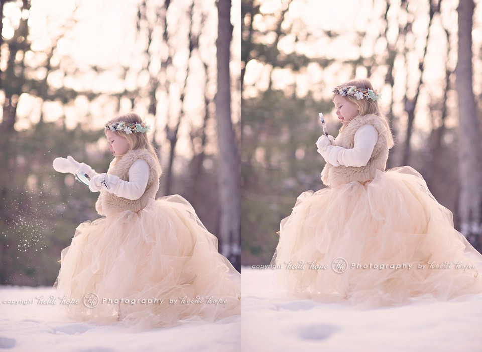 girl in snow with tutu playing with a magnifying glass